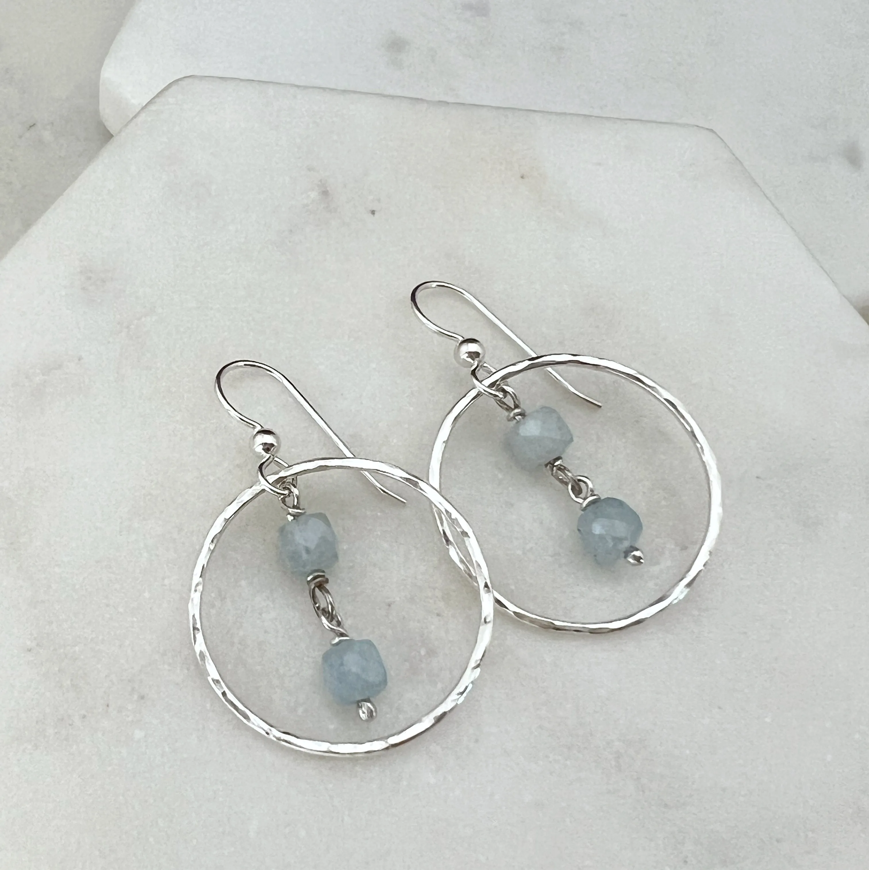 Sterling silver hoop earrings with aquamarine gemstones